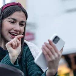 attractive-young-woman-uses-smartphone-christmas-online-shopping_169016-16947