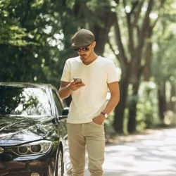 handsome-man-with-phone-by-car_1303-9832
